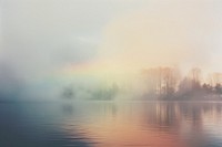 A lake with mist floats in the air outdoors nature sky. AI generated Image by rawpixel.