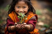 Bhutan kid child plant happy. AI generated Image by rawpixel.