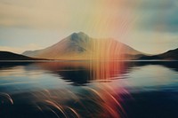 A lake with a mountain in the background landscape outdoors rainbow. AI generated Image by rawpixel.