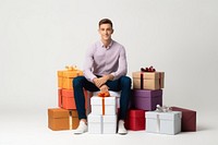 Stacking gift boxes sitting adult man. AI generated Image by rawpixel.