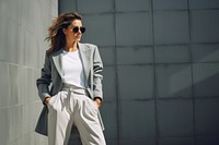 Young elegant woman in grey jacket and white pants sunglasses outdoors fashion. AI generated Image by rawpixel.