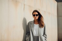 Young elegant woman in grey long jacket sunglasses outdoors blazer. AI generated Image by rawpixel.