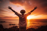 Happy man weating a hat with arms up enjoy freedom at the beach at sunset outdoors nature adult. AI generated Image by rawpixel.