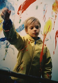 A kid painting on the mirror hand photography portrait. AI generated Image by rawpixel.