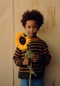 A black boy carry a big sunflower photography portrait plant. AI generated Image by rawpixel.