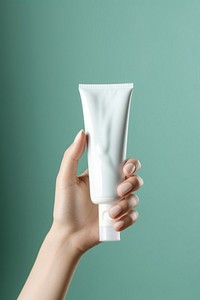 Hand cream holding toothpaste cosmetics. AI generated Image by rawpixel.