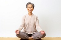 Asian senior woman doing yoga meditation sitting adult cross-legged. AI generated Image by rawpixel.