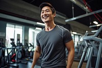 Asian man in sportswear walking in a gym smiling fitness smile. 