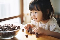 Feeding your child chocolate and oatmeal food bowl innocence. AI generated Image by rawpixel.