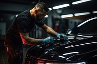 A man putting polish on the headlights car vehicle adult. AI generated Image by rawpixel.