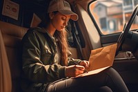 A courier woman sitting vehicle reading. AI generated Image by rawpixel.
