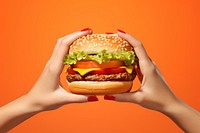 Hand holding burger food hamburger vegetable. AI generated Image by rawpixel.
