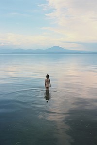 A person walking in the lake sea reflection outdoors. AI generated Image by rawpixel.