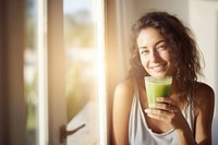 A Smiling woman drinking detox juice at home smiling smile happy. AI generated Image by rawpixel.