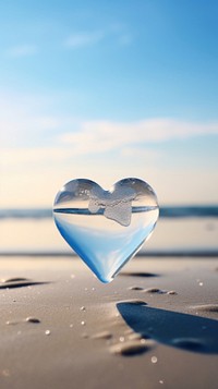A heart made of glass beach tranquility reflection. AI generated Image by rawpixel.