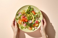 Hands holding salad on plate adult food vegetable. AI generated Image by rawpixel.