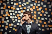 Young businessman planning success holding adhesive note photography portrait adult. AI generated Image by rawpixel.