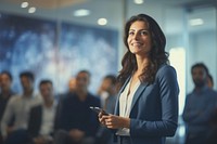 A business woman standing confidently and giving presentation to her collegues in meeting room office adult smile. AI generated Image by rawpixel.