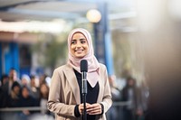 A muslim woman standing of stage going to give a presentation to audience microphone adult architecture. AI generated Image by rawpixel.