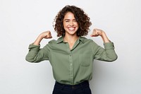 A Portrait of confident strong happy young woman looking at camera with smile and flexing her arm laughing standing portrait. AI generated Image by rawpixel.