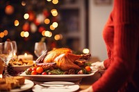 A woman serving roasted turkey on the table and celebrating holiday dinner thanksgiving tradition. AI generated Image by rawpixel.