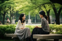Asian woman park conversation outdoors. AI generated Image by rawpixel.