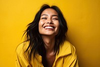 Asian woman laughing smiling yellow. 