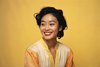 Asian woman smiling yellow adult. AI generated Image by rawpixel.