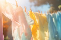 Water mist between dry clothes day clothesline clothespin. AI generated Image by rawpixel.