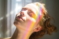 Rainbow ray lay down on woman face portrait adult photo. AI generated Image by rawpixel.