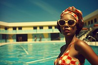 An african woman wearing swimming suit architecture photography sunglasses. 