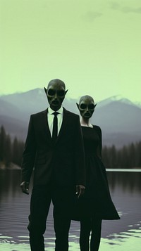 A couple wearing alien mask dressing beautiful standing infront of the river photography sunglasses silhouette. AI generated Image by rawpixel.