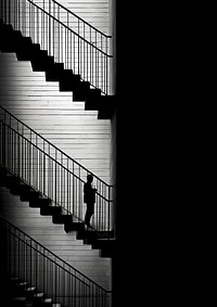 A man sitting on the stair architecture staircase building. 