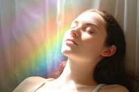 Rainbow ray lay down on woman face portrait photo contemplation. AI generated Image by rawpixel.
