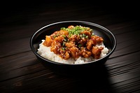 A korean fries chicken on top of the rice in the black bowl on the black wood table food meat chopsticks. AI generated Image by rawpixel.