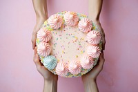 Hands holding birthday cake dessert icing food. AI generated Image by rawpixel.