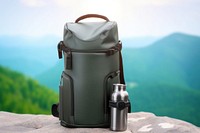 Vacuum flask sitting on the mountain backpack bottle bag. AI generated Image by rawpixel.