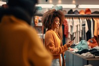 Sweater in front of clothes lack adult store woman. 