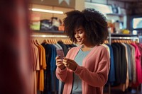 Sweater in front of clothes lack adult store woman. AI generated Image by rawpixel.