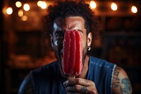 Young man eating strawberry ice lolly adult food face. AI generated Image by rawpixel.