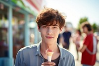 Young man eating strawberry ice lolly adult happy face. AI generated Image by rawpixel.