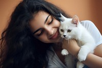 Latinx young woman playing with a kitty photography portrait animal. AI generated Image by rawpixel.