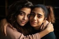 Two Hispanic lesbian women hugging each other and looking on the camera photography portrait people. AI generated Image by rawpixel.