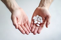 Hand holding pills medication medicine recovery. 