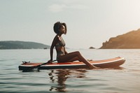 Black girl resting on paddleboard oars watercraft sitting. AI generated Image by rawpixel.