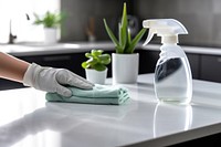 Cleaning home table sanitizing kitchen table surface with disinfectant spray bottle washing surfaces with towel and gloves container housework seasoning. 