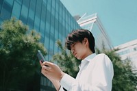 Japanese businessman in Tokyo with smart phone texting outdoors architecture technology telephone. AI generated Image by rawpixel.