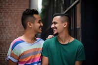 Latinx Two happy smiling friends from lgbt community standing looking at each other together laughing adult togetherness. AI generated Image by rawpixel.