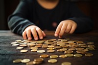 Child counting coins money hand investment. AI generated Image by rawpixel.