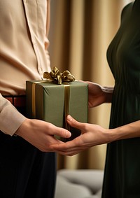 Dark green large gift box holding adult hand. AI generated Image by rawpixel.